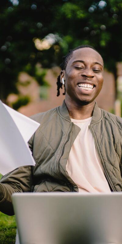 Student with documents and laptop happy about getting into university